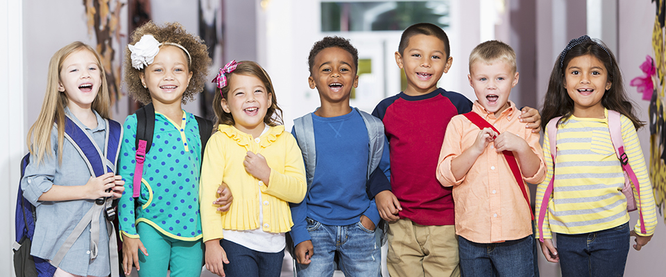 Multiracial group of children in preschool hallway